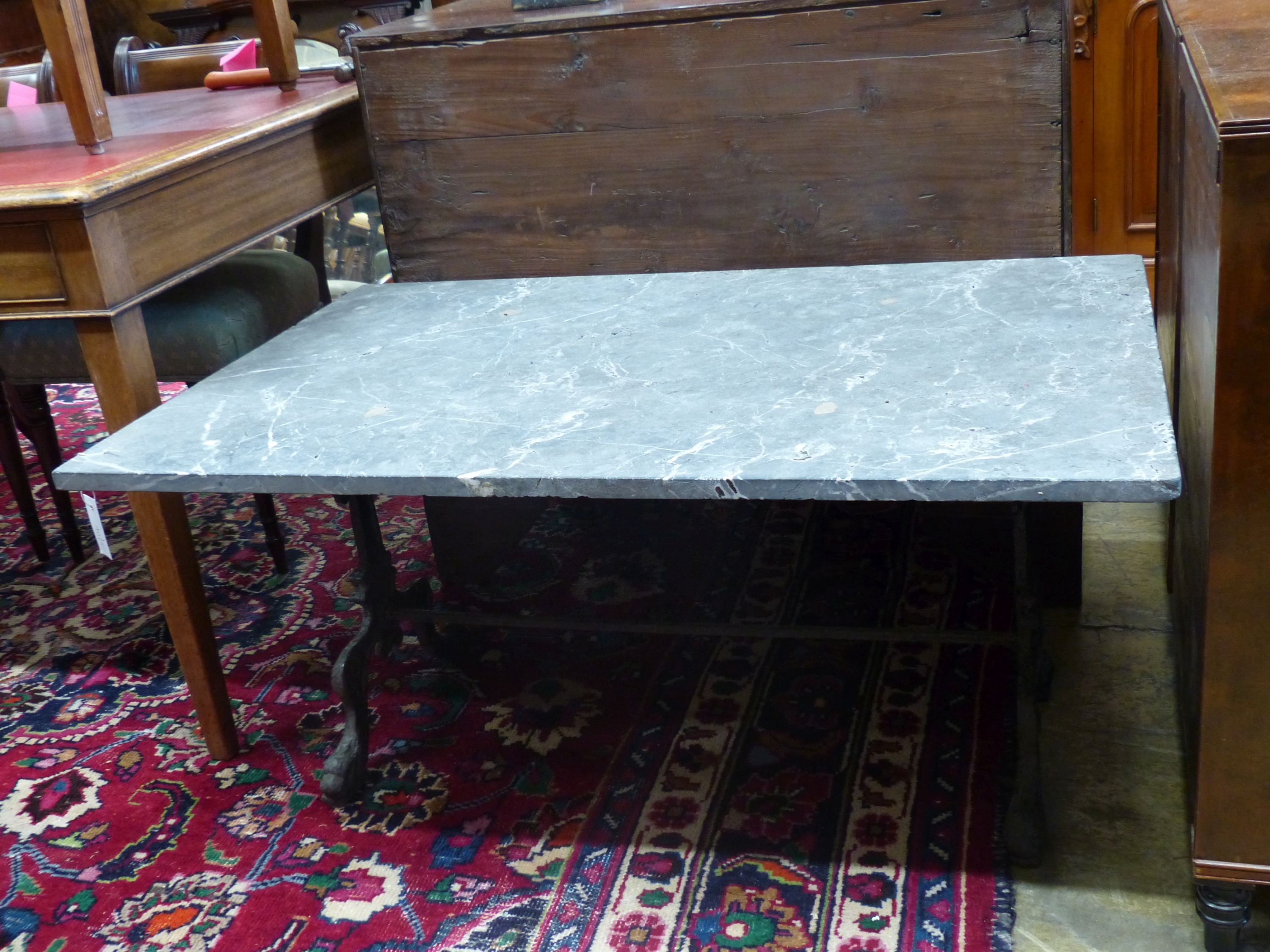 A rectangular marble top cast iron coffee table, width 108cm, depth 71cm, height 50cm